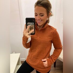 Light pullover size small dark orange with white on the end of the sleeves